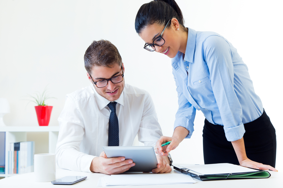 Portrait of business people working in the office with digital tablet.